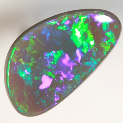 SOLID BLACK OPAL Neon turquoise and green in large rolling flashes. SEE VIDEO